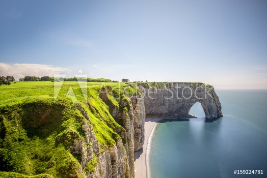 Bild på Landscape view on the famous rocky coastline near Etretat town in France during the sunny day Long exposure image technic with soft water